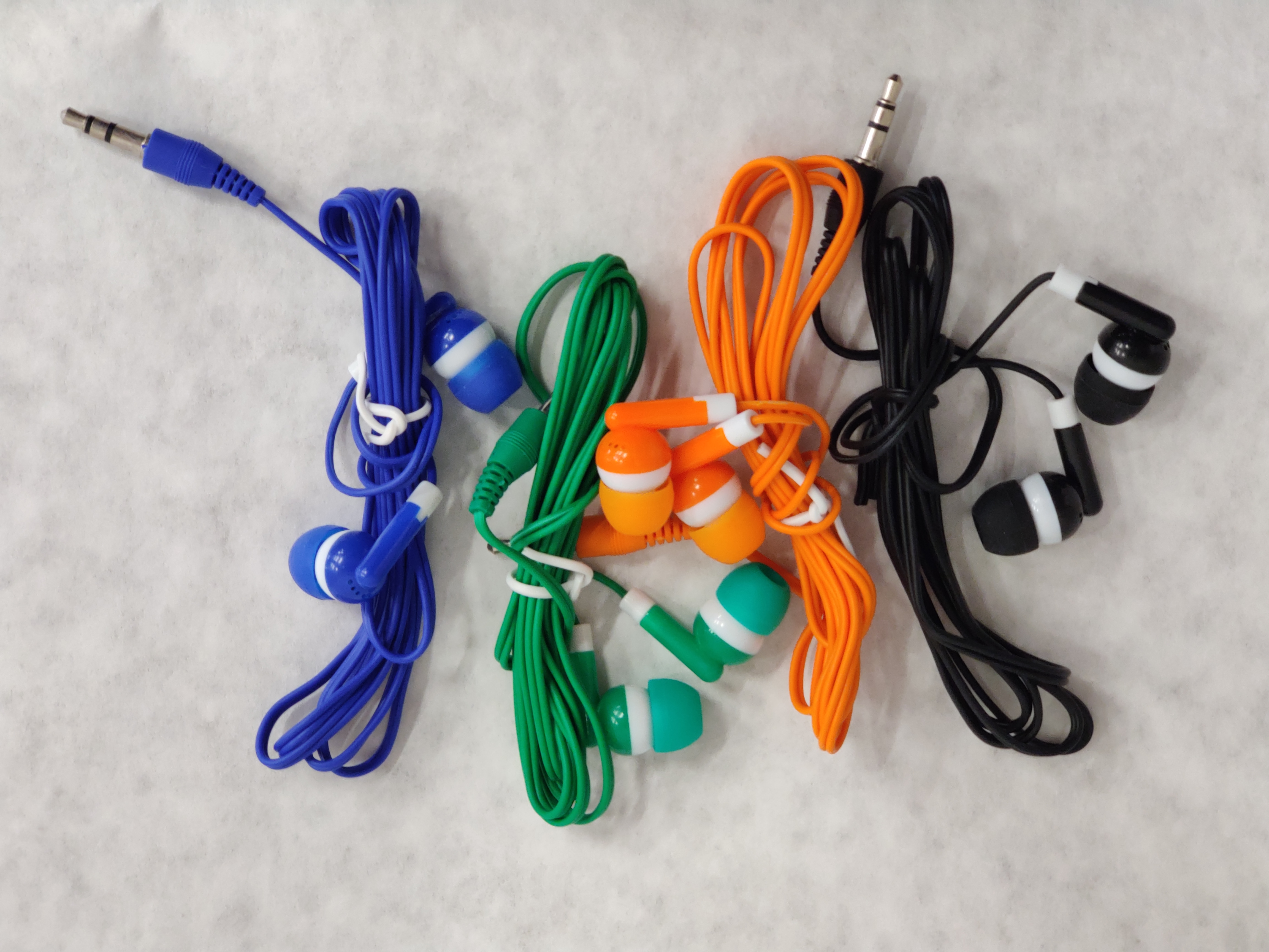 Wrapped earbud sets in blue, green, orange, and black