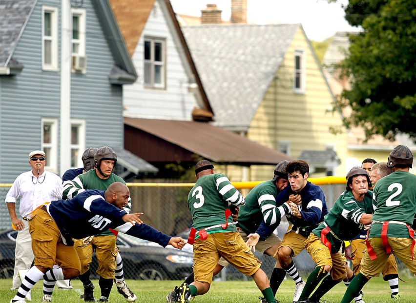Football players on mid game play.