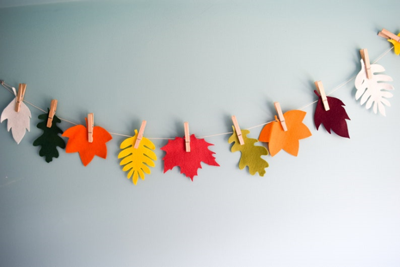 A string of twine with colorful fall leaves attached with little clothespins.