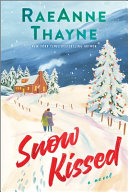 Book cover reading "Snow Kissed" by RaeAnne Thayne, featuring an illustration of a man and woman walking together toward a house set withing a snowy landscape