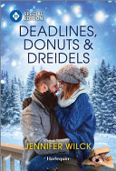 Book cover reading "Deadlines, Donuts and Dreidels" by Jennifer Wilck, featuring a white man and woman leaning in for a kiss against a snowy, forested landscape