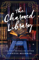 Book cover reading "The Charmed Library" by Jennifer Moorman, featuring an open, glowing book on a stool in front of bookshelves