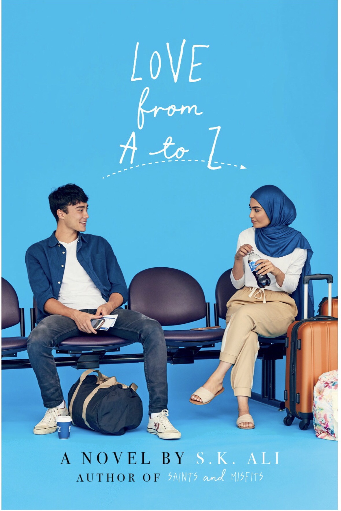 Cover image for Love from A to Z, with the two protagonists seated in chairs looking at each other.