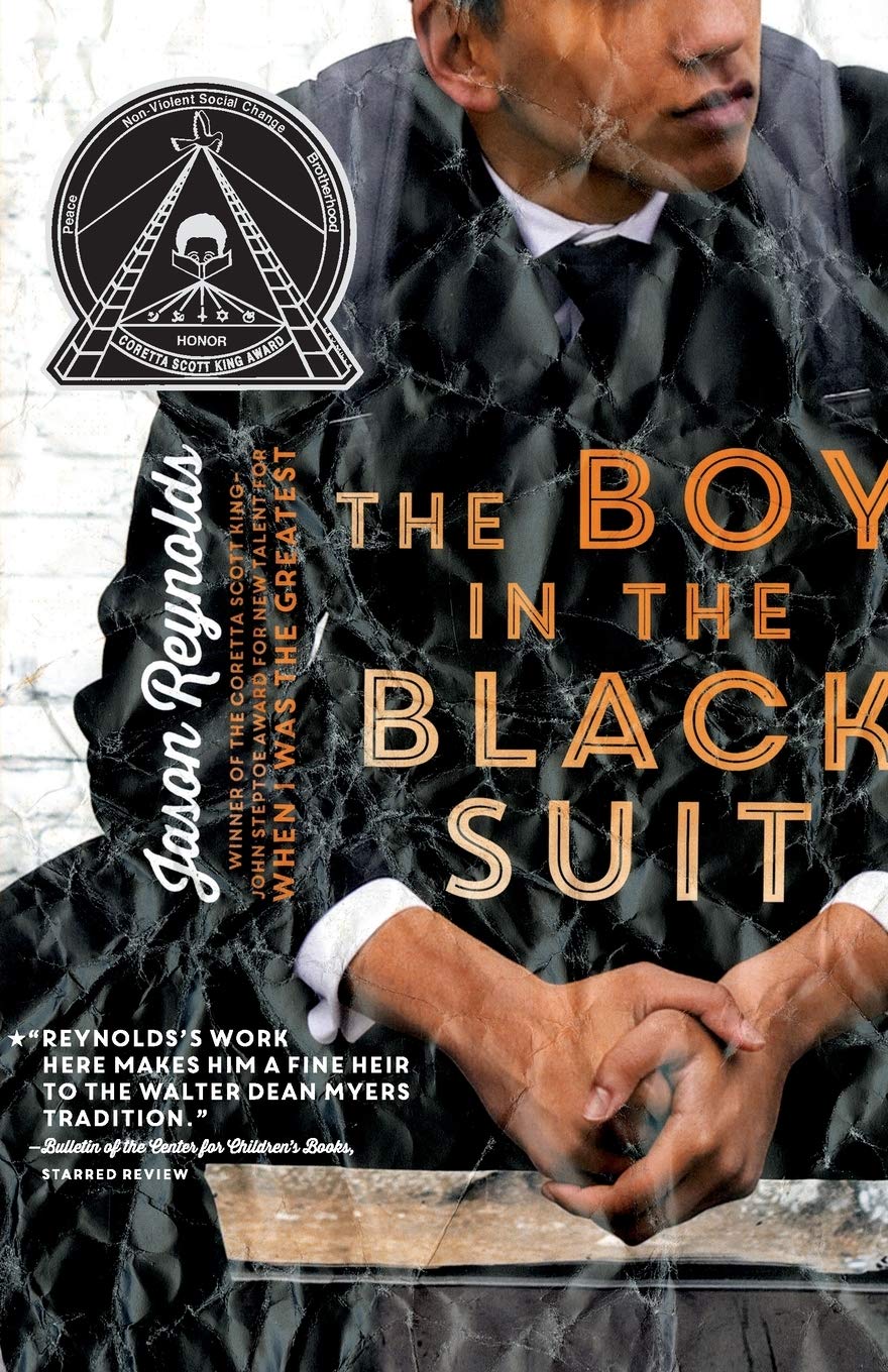 The cover of "The Boy in the Black Suit" by Jason Reynolds pictures a young man wearing a suit.