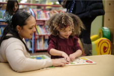 Mother and child working on puzzle in the children's library