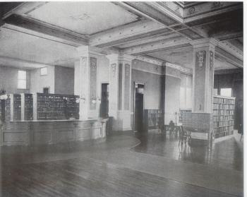 Black and white photo of stacks, main desk ,and card catalog c. 1903