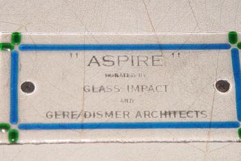 Window plaque reading: "Aspire" donated by Glass Impact and Gere/Dismer Architects