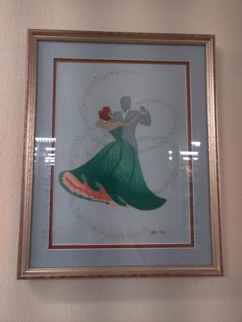 Needlepoint of man and woman in green dress dancing