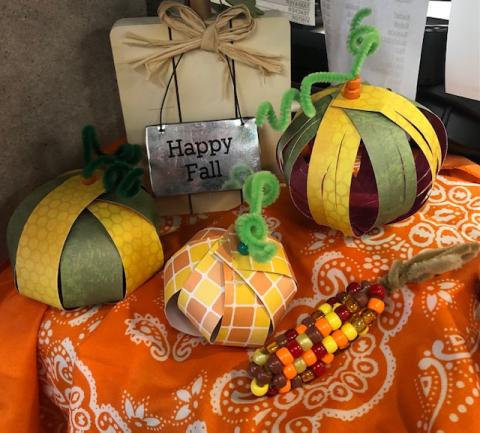 Picture of pumpkins made with paper and chenille stems. Beads on chenille stems by using pony beads.