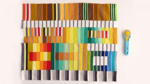 Fabric construction into a quilt top that has the appearance of ribbons by Sarah Bond.