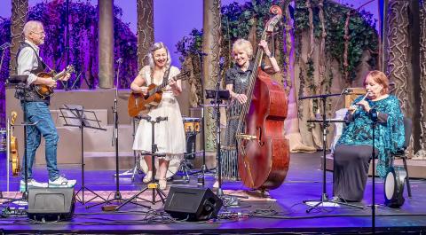 Band photo featuring 4 members of the Bucktown Americana Music Show performing on stage