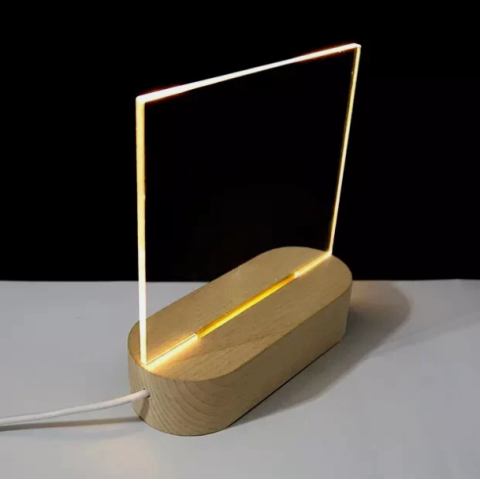 A light up frame sits on a white table with a black background; for this project, we'll pair this with a metal bookend.