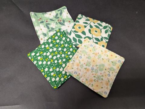 Square, quilted, pieces of fabric in the size of a drink coaster.