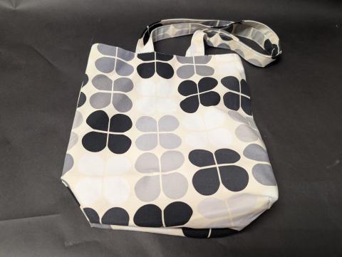 Black and gray floral shopping tote bag.