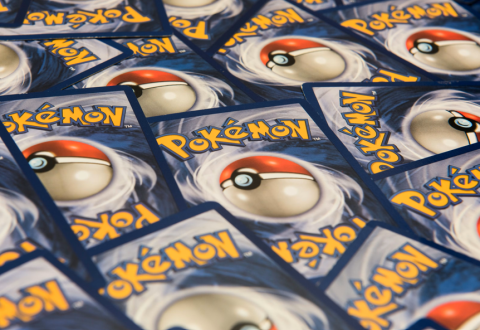 An image of Pokemon cards appears with only the backs of each card visible: this includes a blue border, the yellow Pokemon logo, and a red and white Poke-ball.