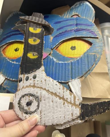 An image of Sussie (the bird) and Derpy (the tiger) from KPop Demon Hunters rendered in cut out cardboard. 