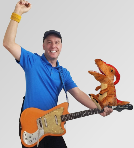 Leonardo in a blue shirt with an orange guitar and a dragon sitting on the neck of the guitar.
