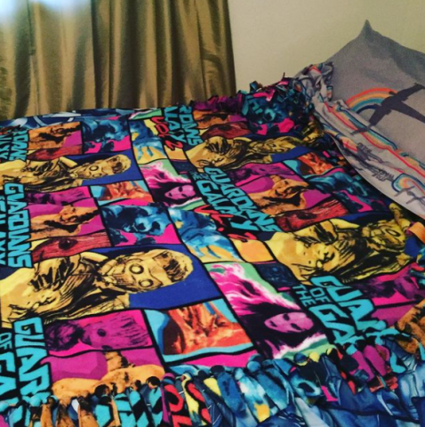 Fleece tie blanket on a bed.