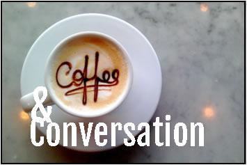 White coffee cup with Coffee written in foam on top with conversation underneath