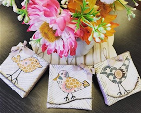 Picture of flowers with 3 bird magnets.