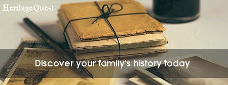 A tied bundle of old documents with an old ink pen beside it