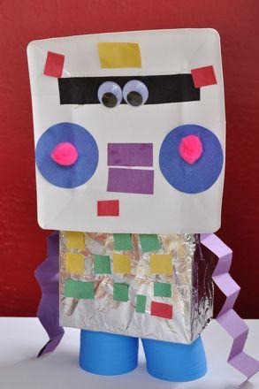 Homemade robot with blue and pink cheeks, purple crinkly arms and blue legs.  