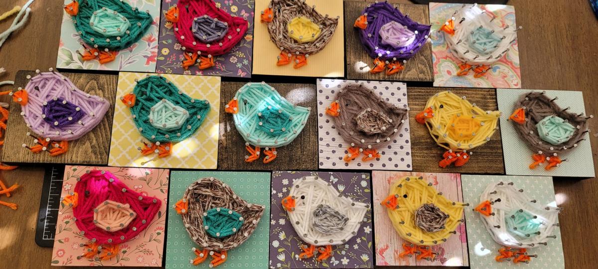 Photo of many colorful yarn chick creations