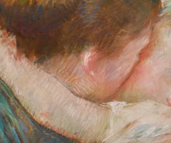 Close up shot of mother kissing her child on the cheek