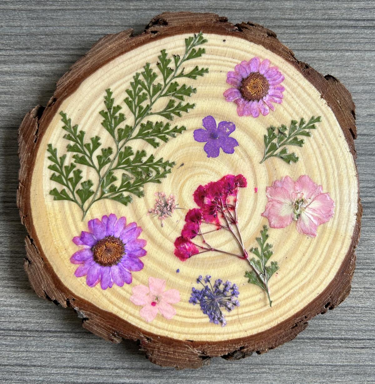 Image of wooden coaster with dried flowers