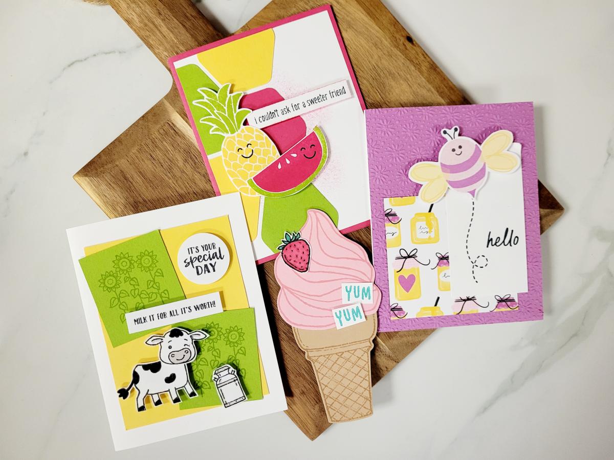 Image of three summer-themed greeting cards on wooden cutting board