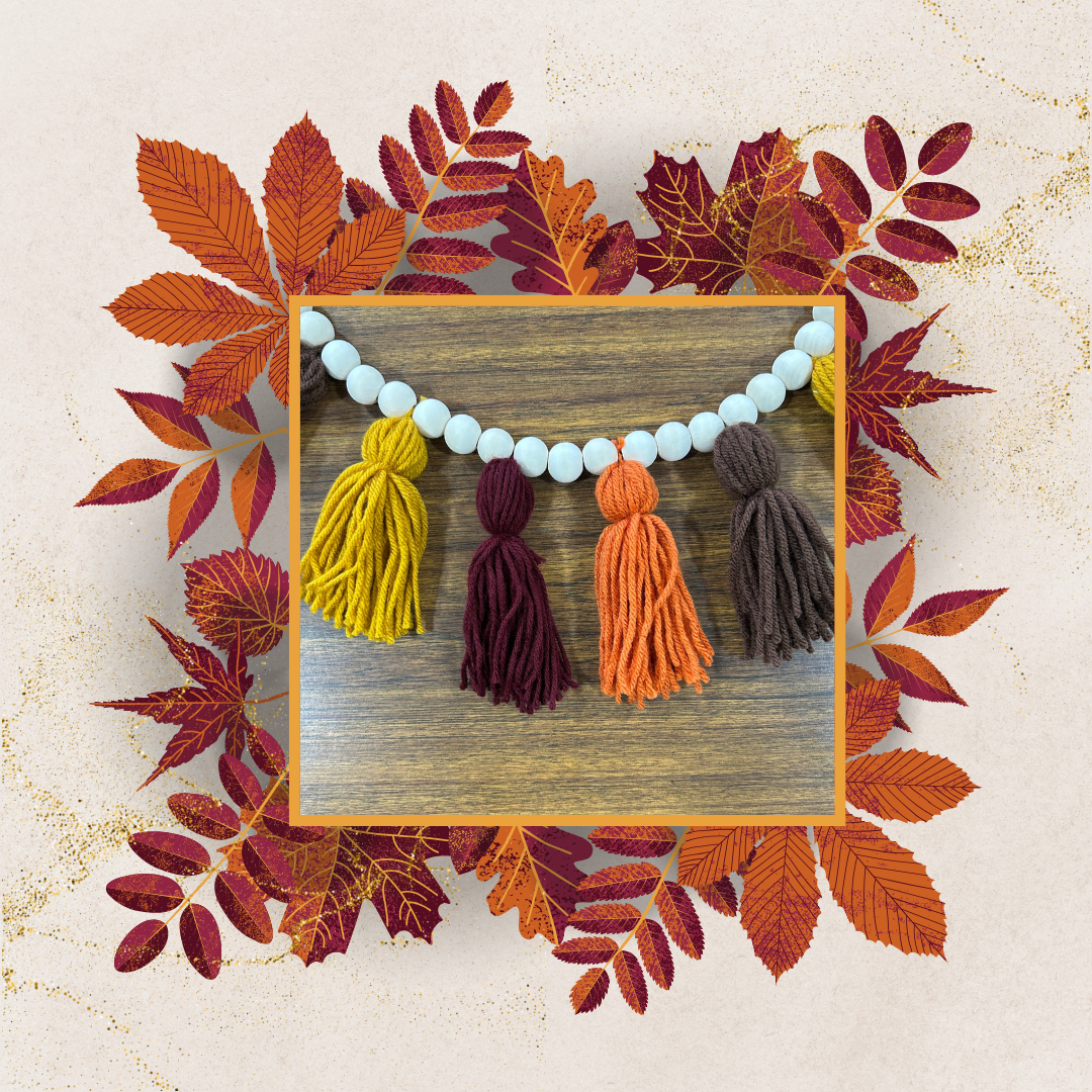 Photo of yarn tassel garland craft bordered by fall leaves
