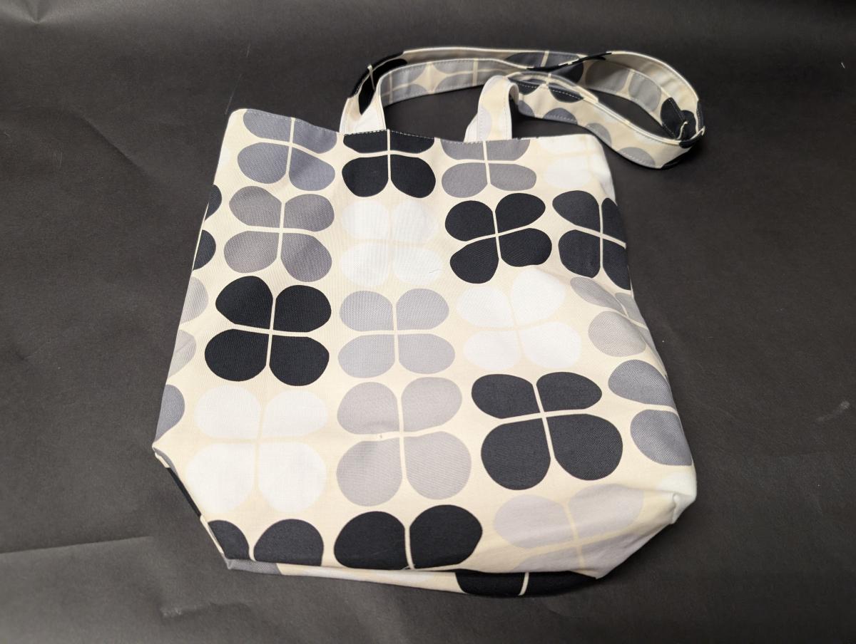 Black and gray floral shopping tote bag.