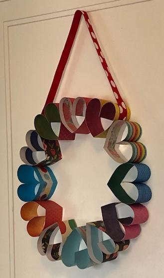Creat hearts with colorful papers and attach them to form a wreath for Valentine's day.