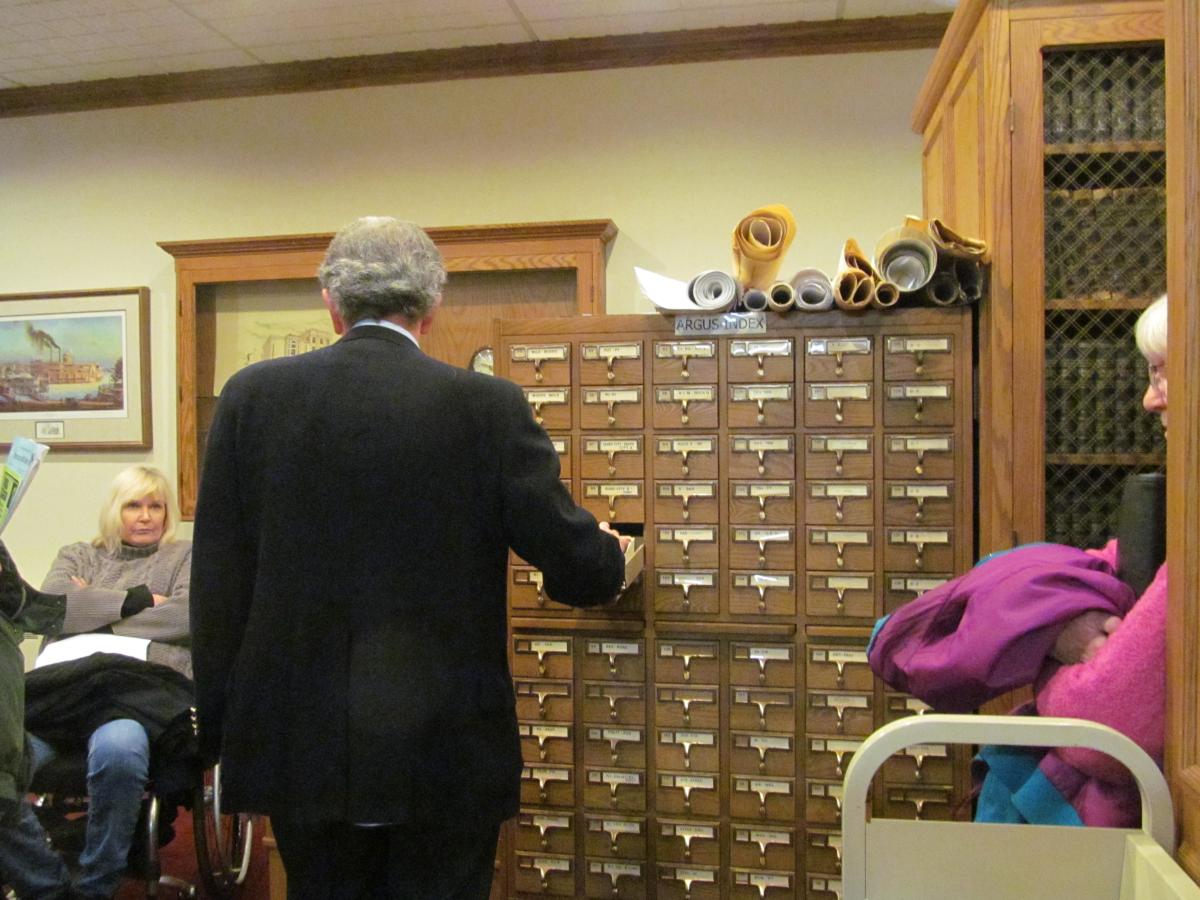 Library staff member James S showing the history room catalog. 