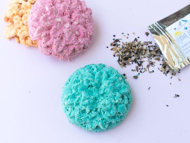 Picture of blue and pink paper seed bomb with a packet of open flower seeds